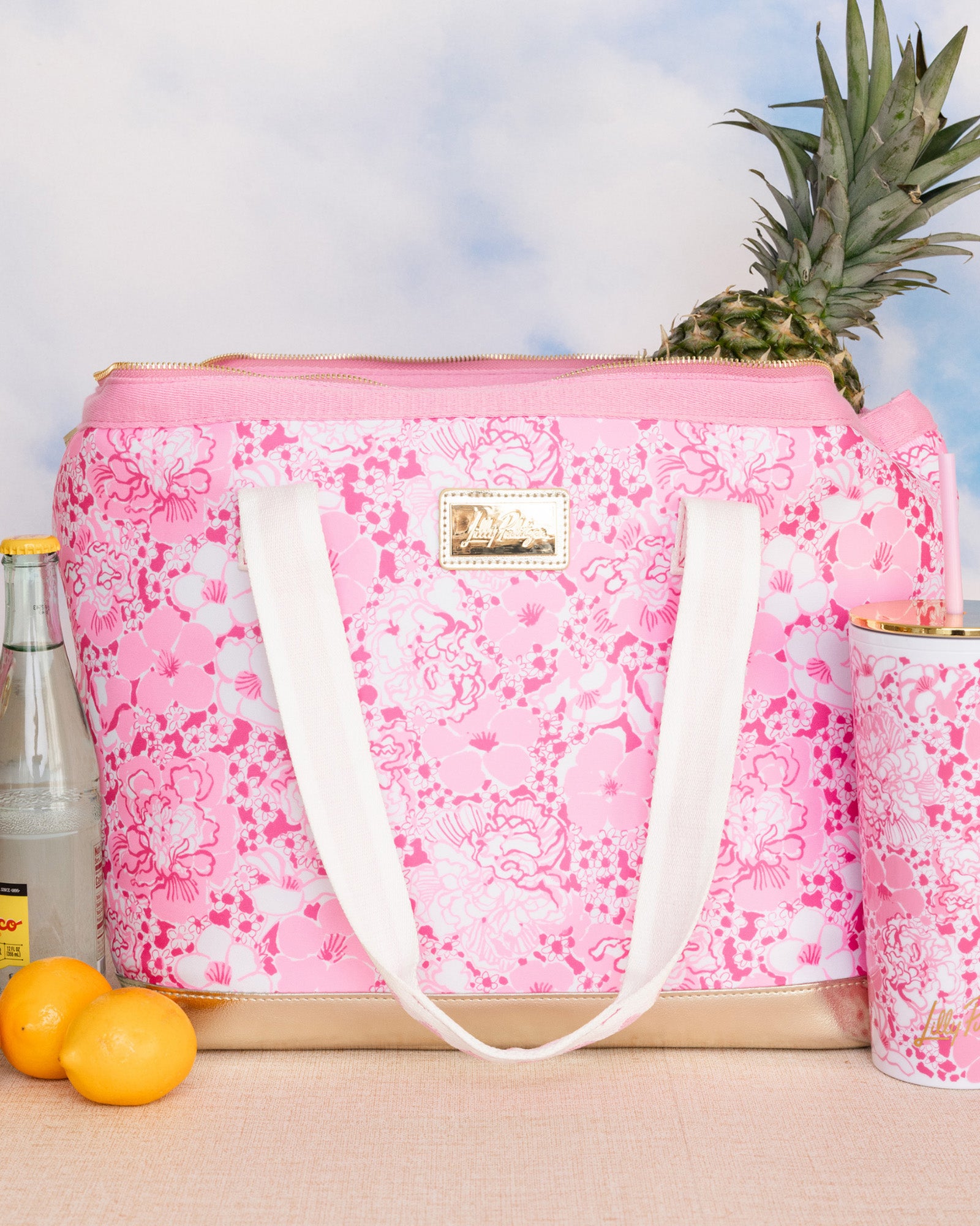 pink and white floral print cooler bag with whit strap with ric rac detail and gold bottom with matching tumbler