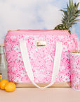 pink and white floral print cooler bag with whit strap with ric rac detail and gold bottom with matching tumbler