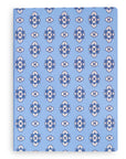 Notebook with blue and white floral pattern on a white background