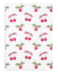 Patterned fabric with cherries and checkered leaves on a white background