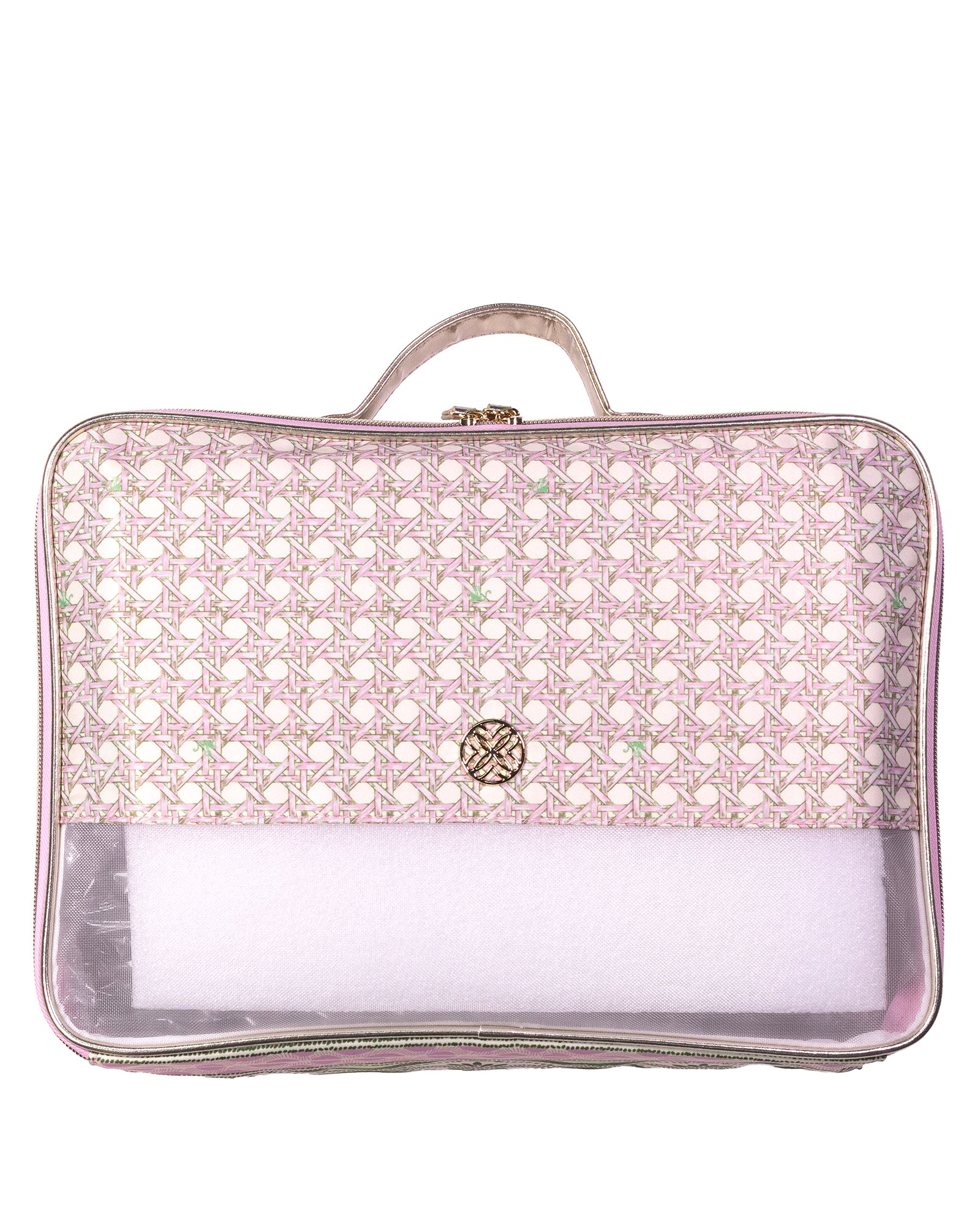 A rectangular travel packing cube with a top handle, featuring a light pink and white geometric patterned upper half, a small gold-tone circular logo on the front, and a clear plastic bottom compartment containing white packing paper.