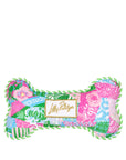 Colorful bone-shaped pillow with floral patterns and a Lilly Pulitzer logo on a white background