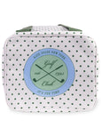 White polka dot bag with green strap on a white background
