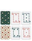 Set of playing cards with decorative designs on a white background