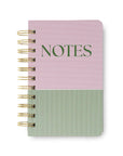 Notebook with pink and green striped cover and 'NOTES' text on a white background