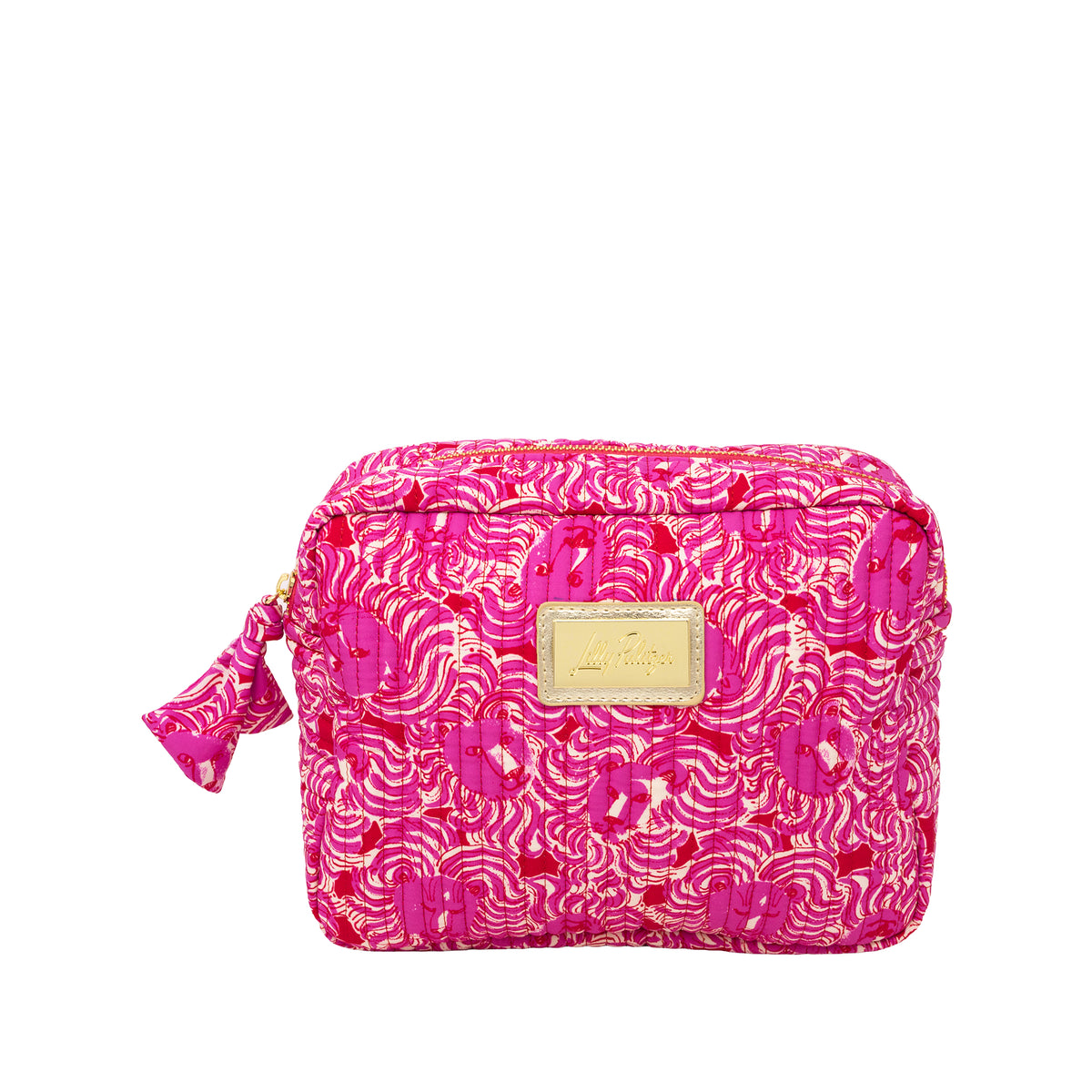 A bright pink cosmetic pouch with a gold and pink abstract wave pattern, featuring a gold-tone metal brand plaque on the front and a matching pink tassel zipper pull.