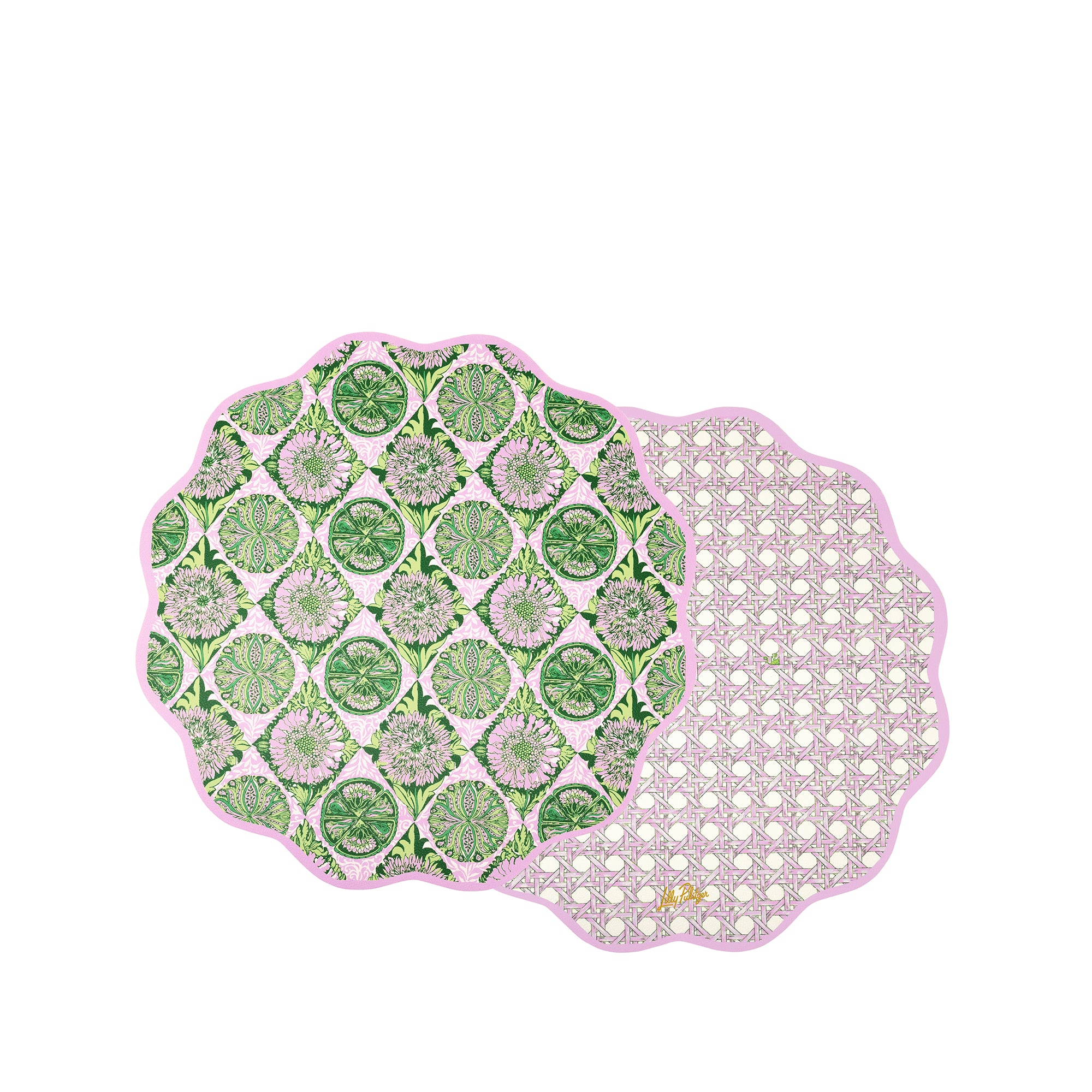 Two scalloped round placemats with a pink border, displayed overlapping on a white background. One placemat features a green and white citrus slice pattern, while the other shows a white lattice pattern on a light pink background.