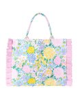 Floral patterned bag with pink ruffle trim on a white background