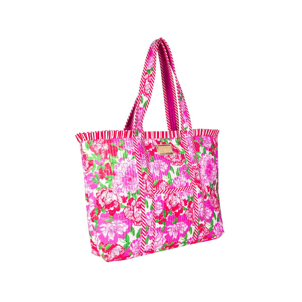 A bright pink tote bag with a floral print, featuring pink and white striped handles and a small gold brand plaque on the front.