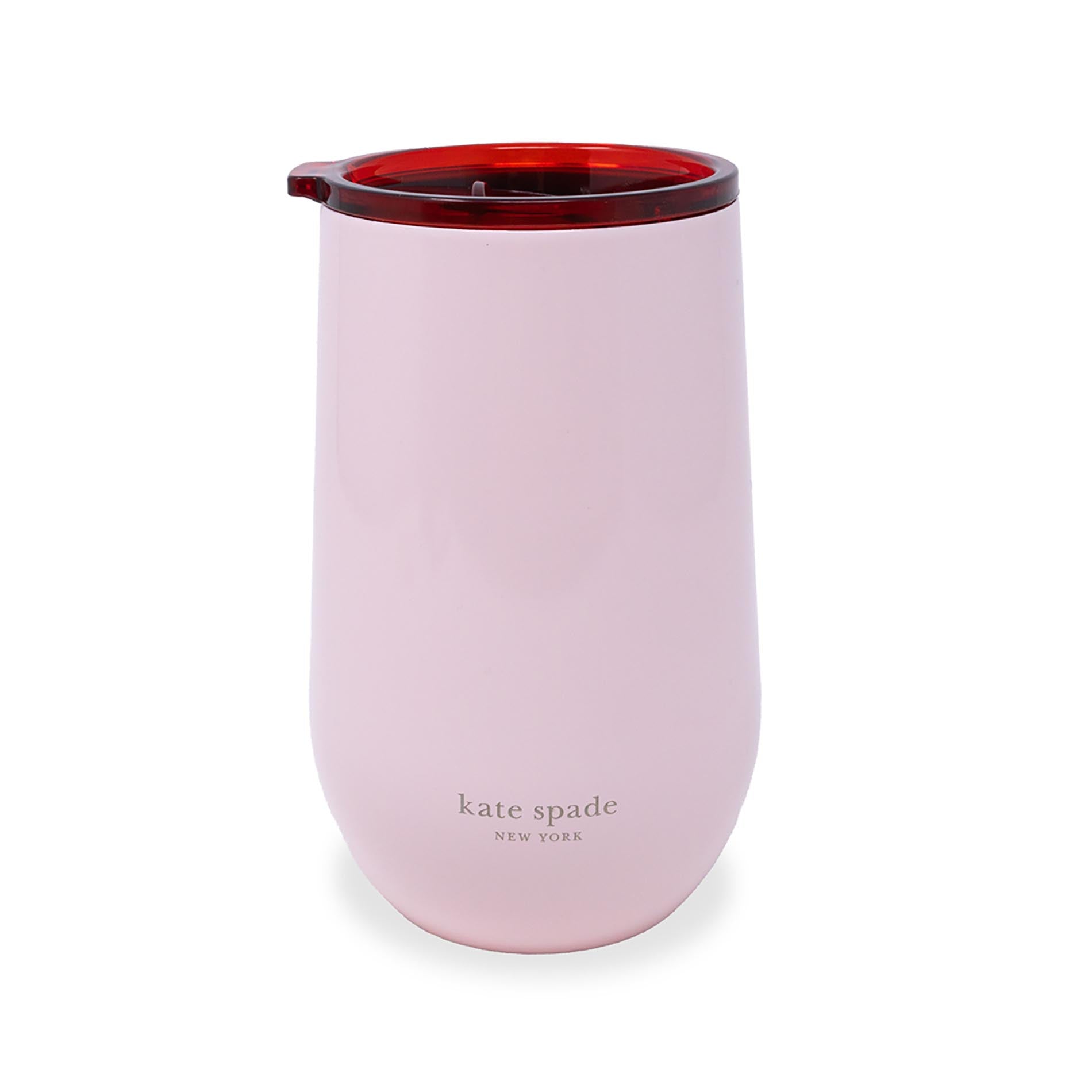 Pink tumbler with red interior on a white background, featuring 'kate spade New York' branding.