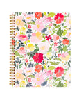 Floral patterned notebook with gold spiral binding on a white background