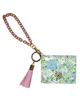 Keychain with floral design and pink tassel on a white background
