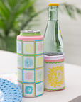 Two can coolers with colorful designs on a white surface.