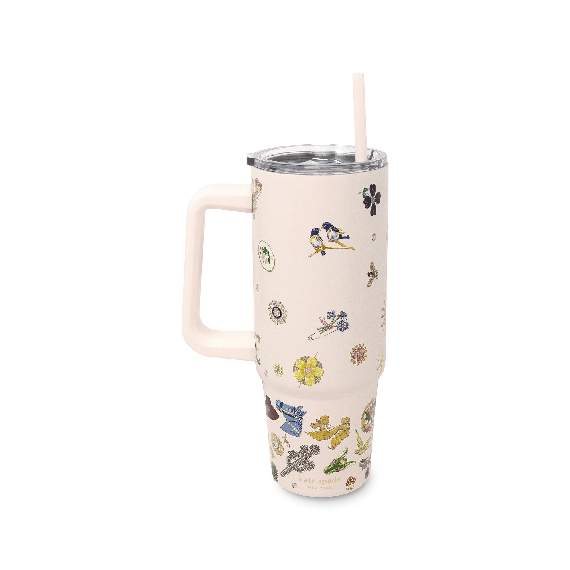 An insulated travel tumbler with a handle, clear lid, and straw, decorated with a whimsical pattern of small birds, flowers, and nature illustrations on a warm cream background.