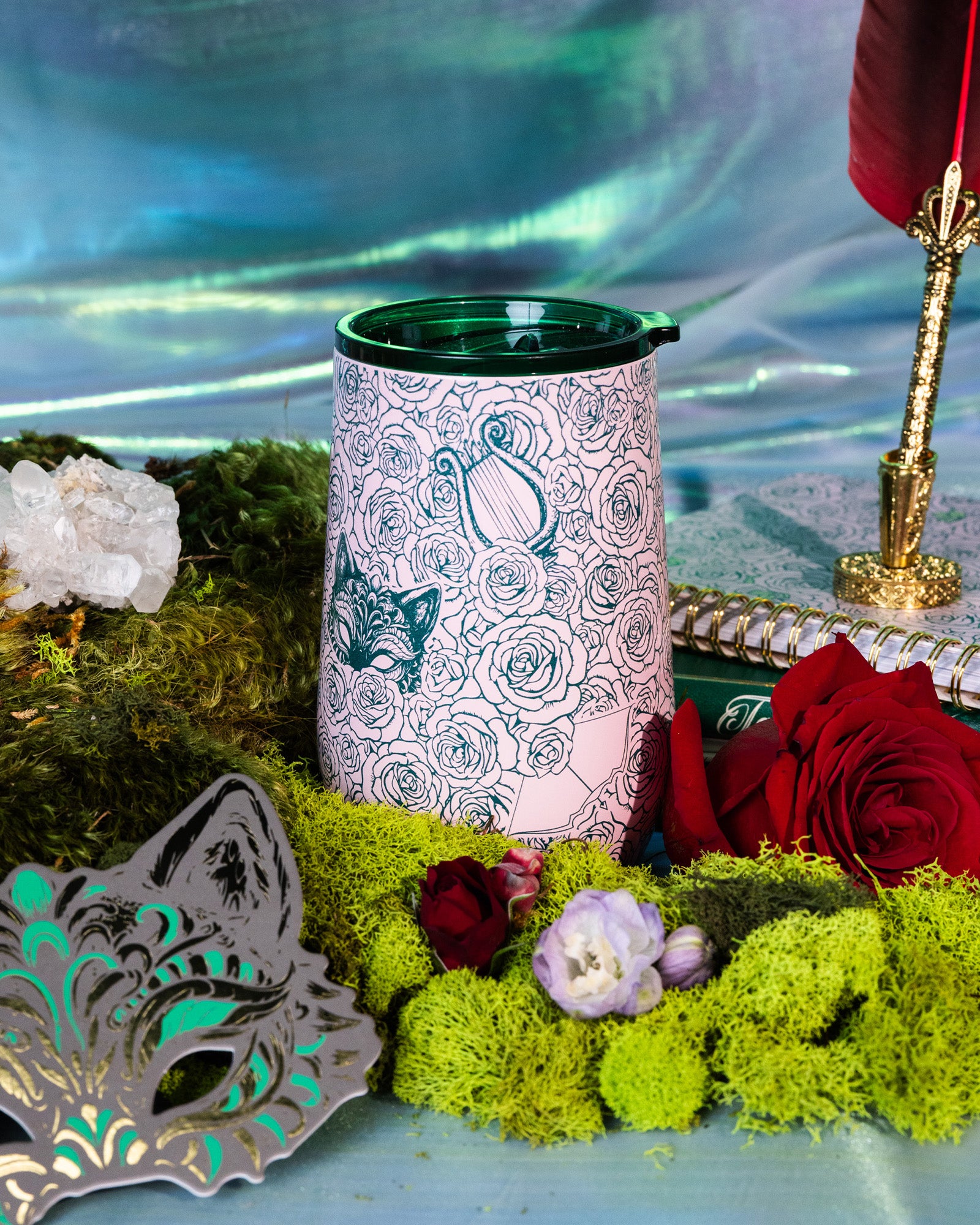 Pink tumbler with rose and butterfly design with a rose and moss background
