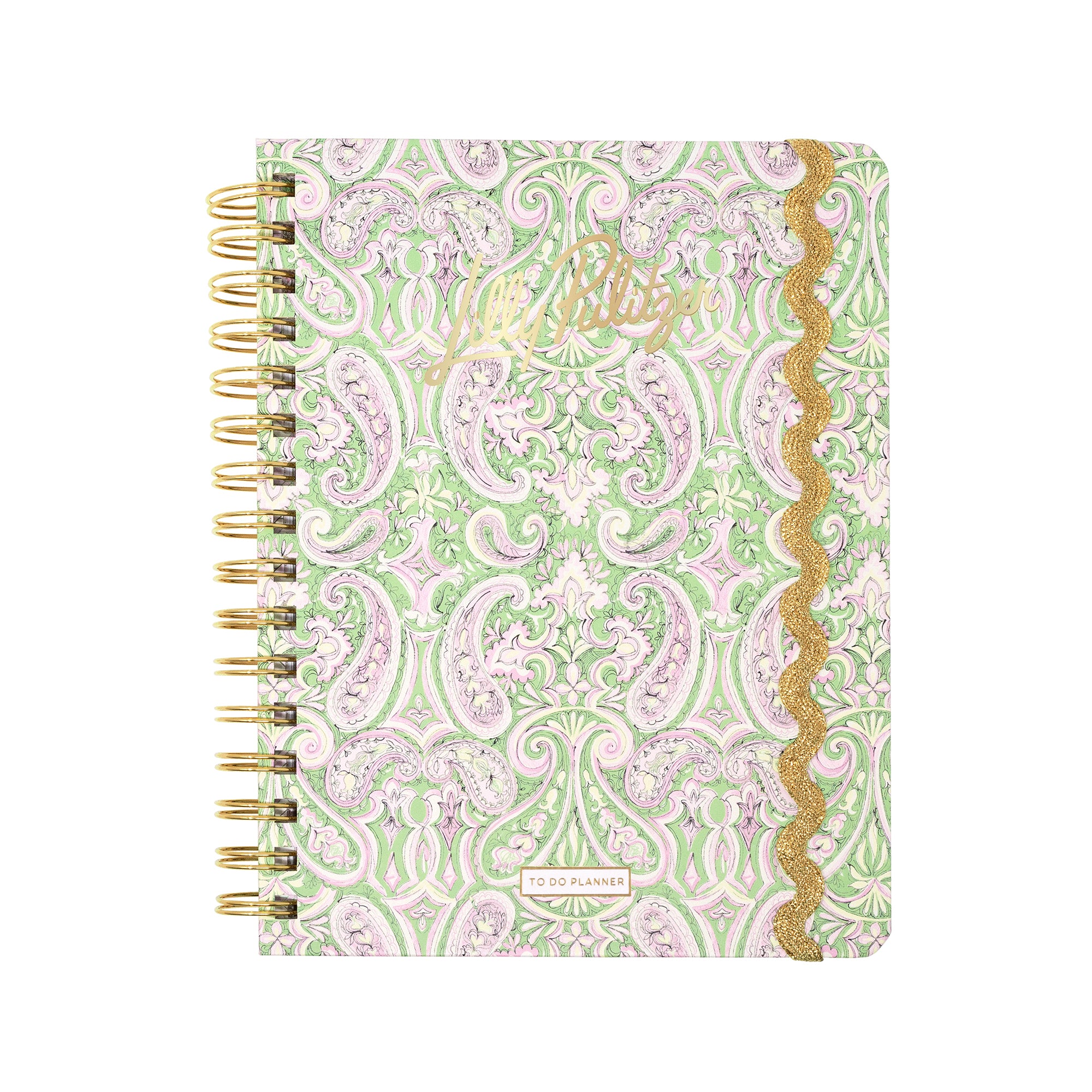 A spiral-bound planner with a light green and lavender paisley pattern, featuring gold foil script on the cover and a gold glittery wavy trim along the right edge.