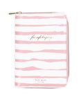 Pink and white striped pouch with 'kate spade new york' branding on a white background