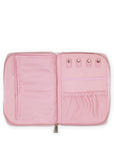 Pink travel organizer with multiple compartments on a white background