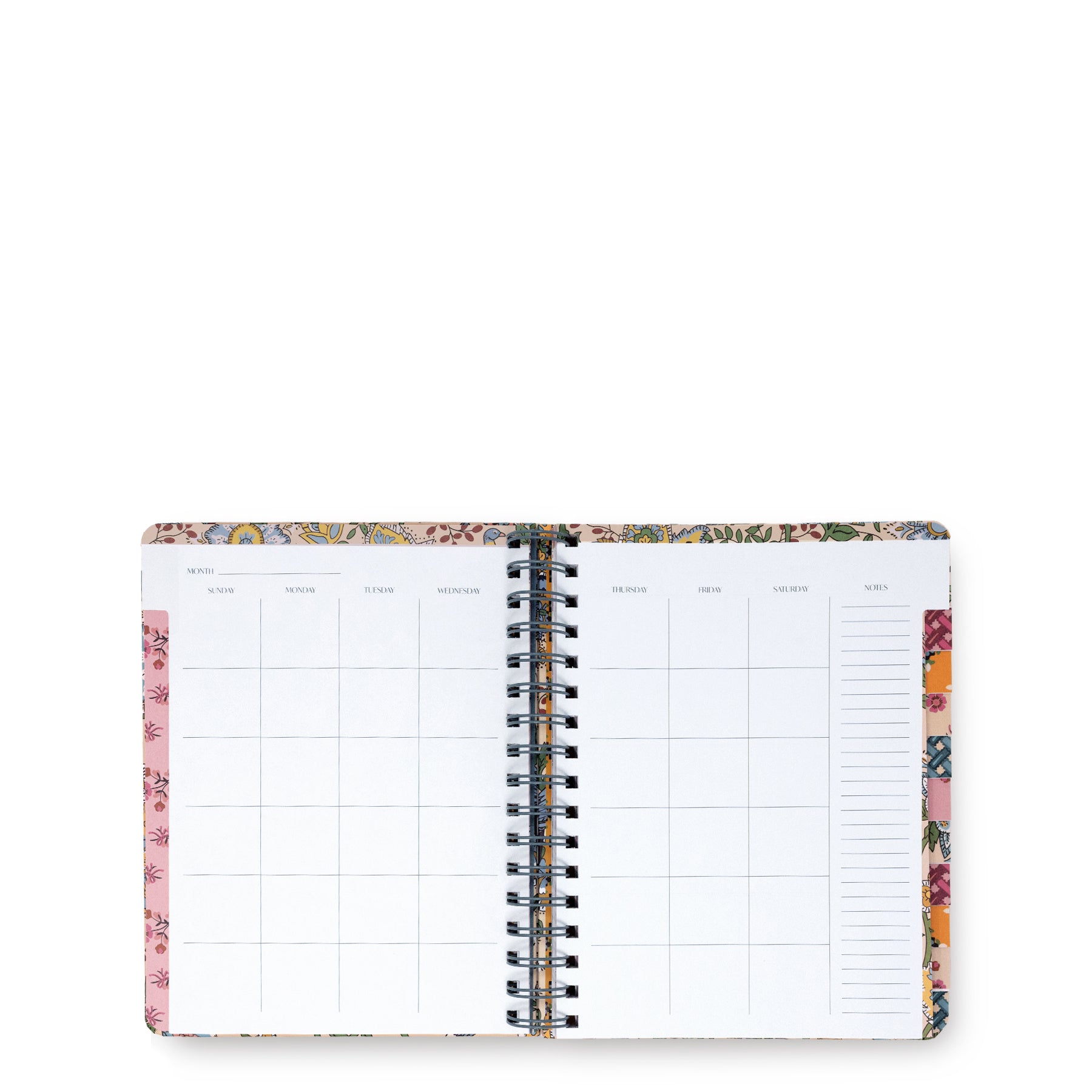 An open spiral-bound planner or agenda with a floral patterned cover and white interior pages, photographed on a plain white background.