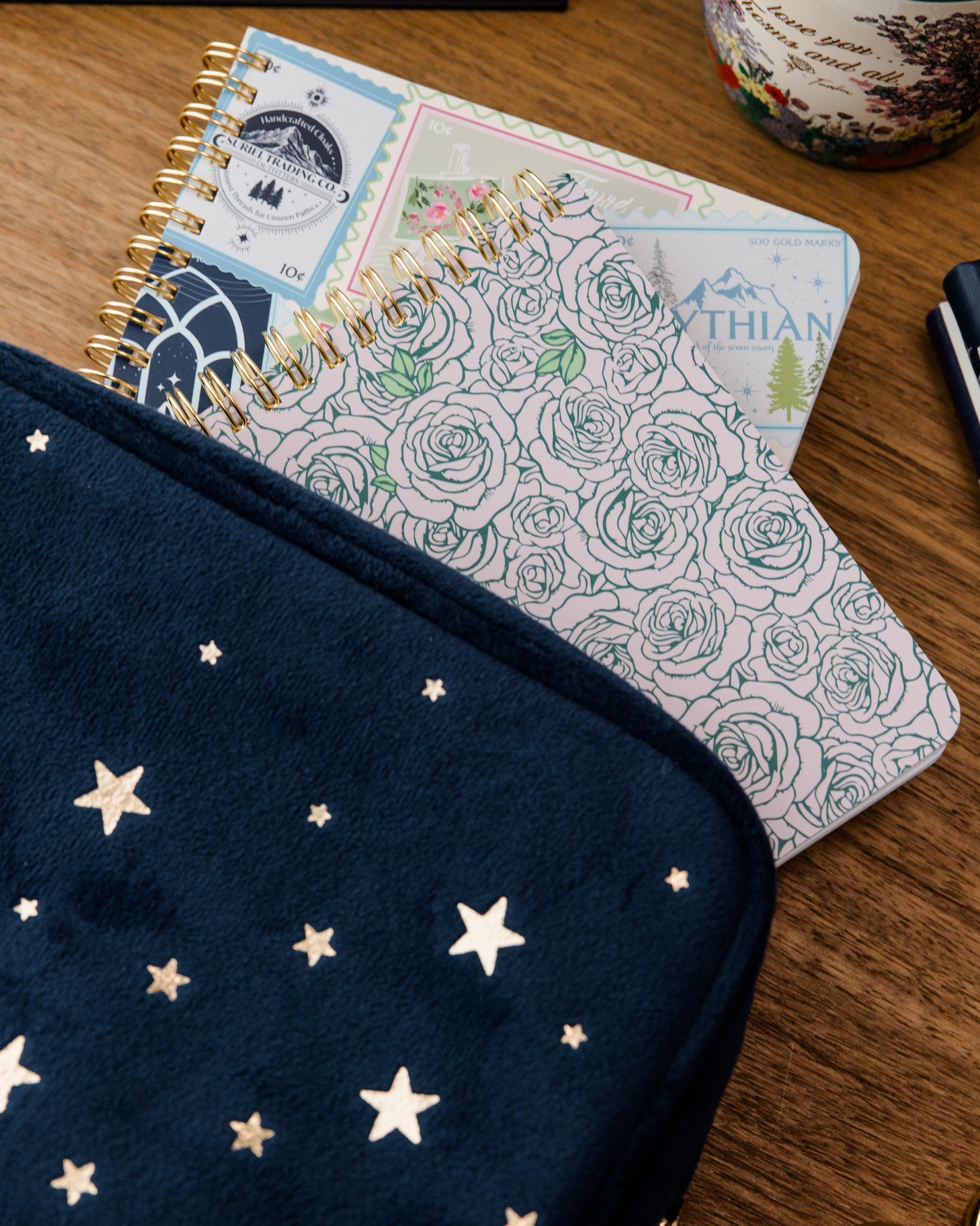 Notebook with star patterned pouch on a wooden surface