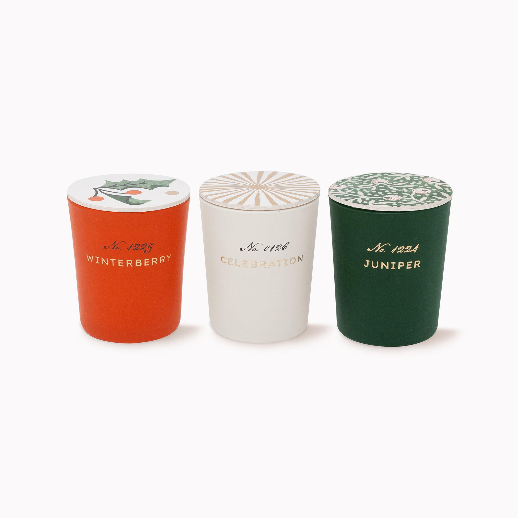 Three decorative cylindrical containers with lids in orange, off-white, and dark green, arranged side by side on a light gray background. Each container has a patterned lid and gold script text on the front.