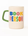Mug with 'BOOK PERSON' text in colorful letters on a white background