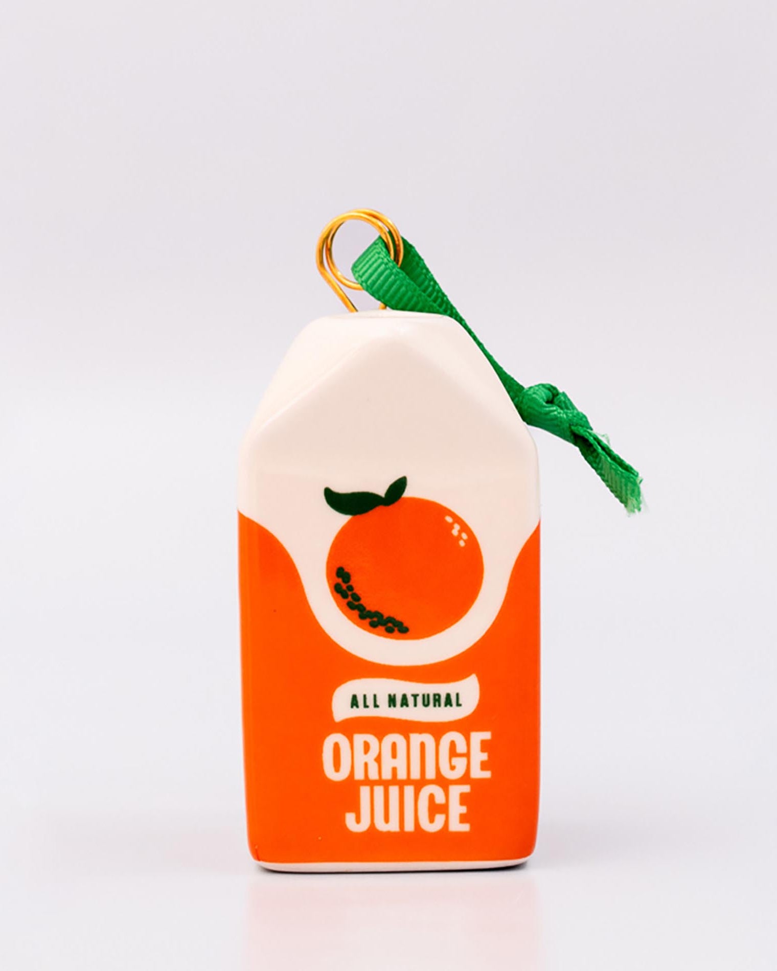 Sideview of ceramic orange juice carton ornament