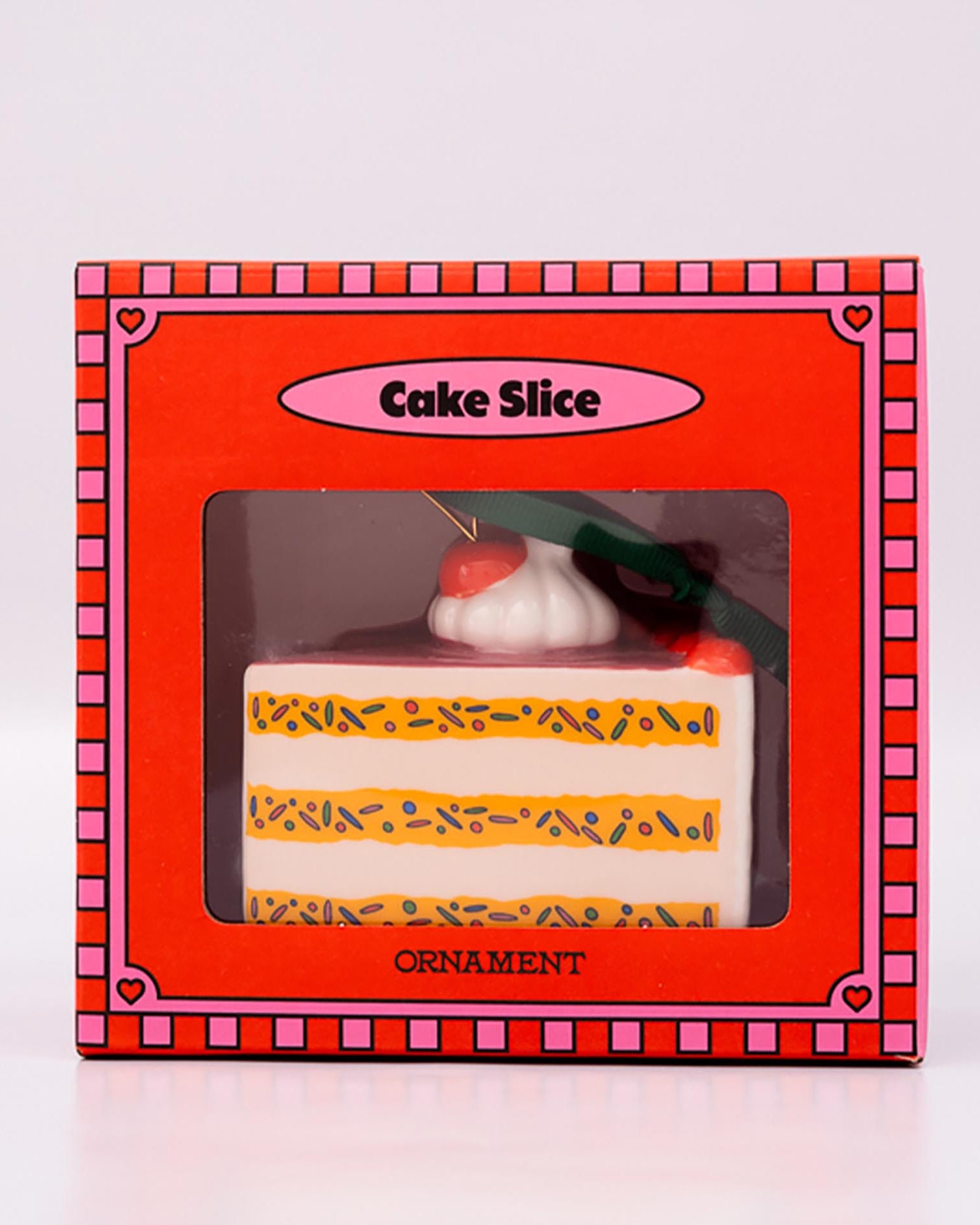 Cake slice ornament in a decorative box on a white background