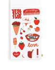 Sheet of stickers with various illustrations including a comb, apples, lips, and ice cream cones on a white background.