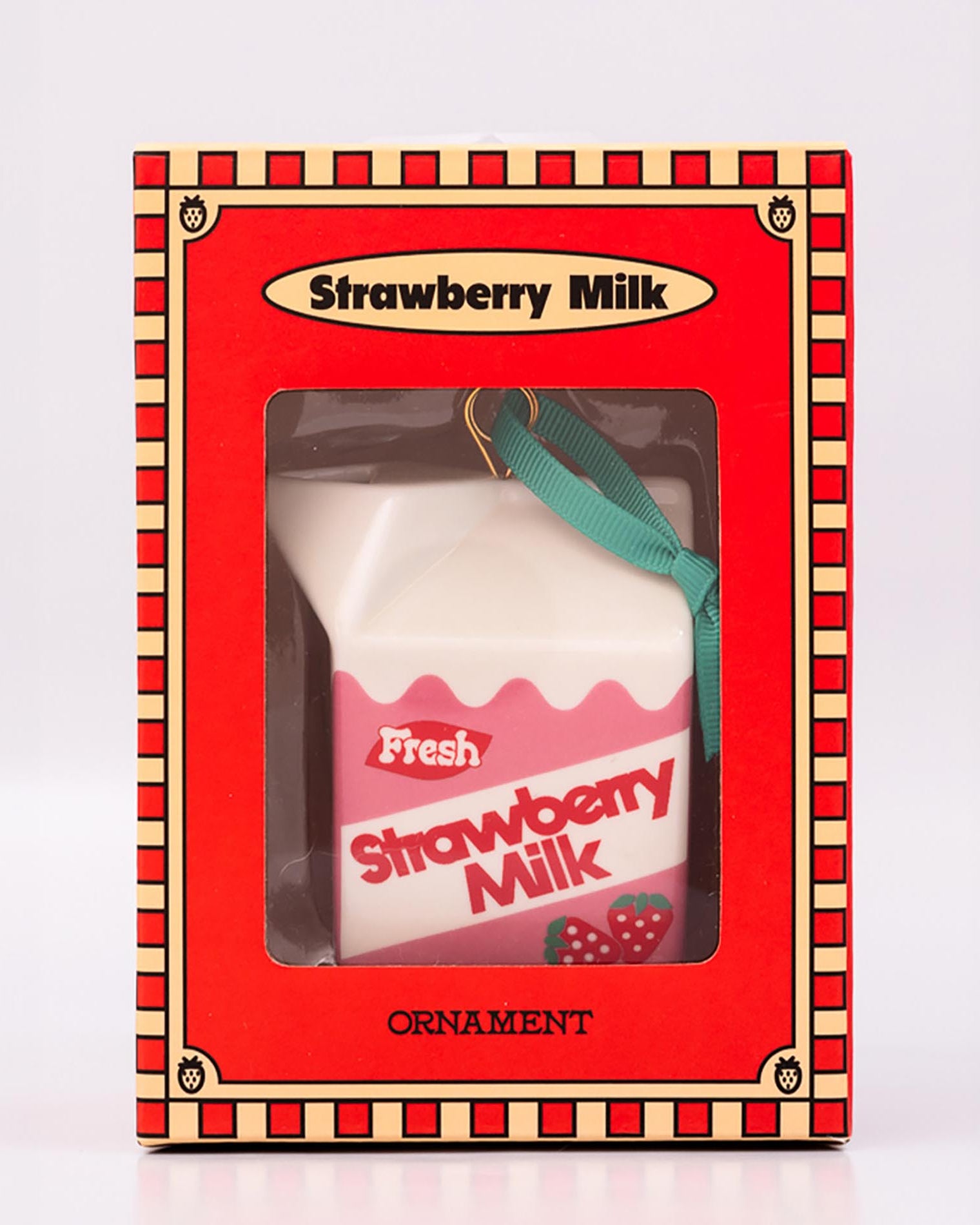 Packaged strawberry milk carton-shaped ornament on a white background