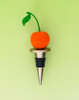 Wine bottle stopper with cherry design on a green background