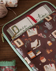 brown book sleeve with colorful cozy book nook icons