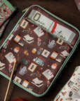 brown book sleeve with colorful cozy book nook icons on a table