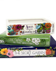 Stack of books with decorative covers on a white background