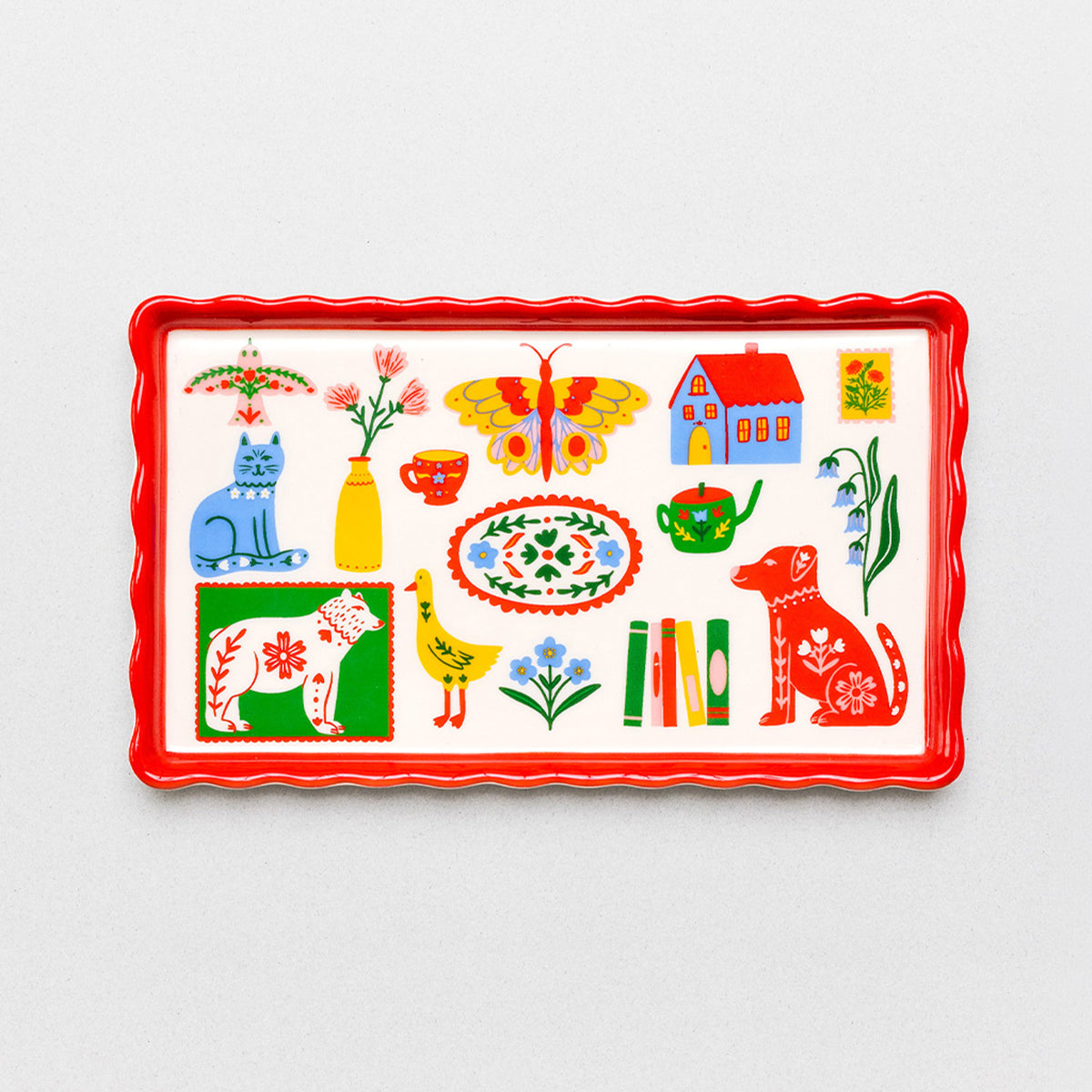 cream rectangular tray with colorful icons (cat, duck, house, butterfly, stamp, flower) across it