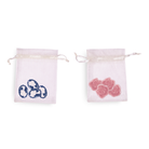 Two small drawstring bags with floral designs on a white background