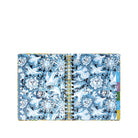 A spiral-bound planner with a detailed blue and white floral pattern, featuring colorful page tabs on the right side, shown against a plain white background.