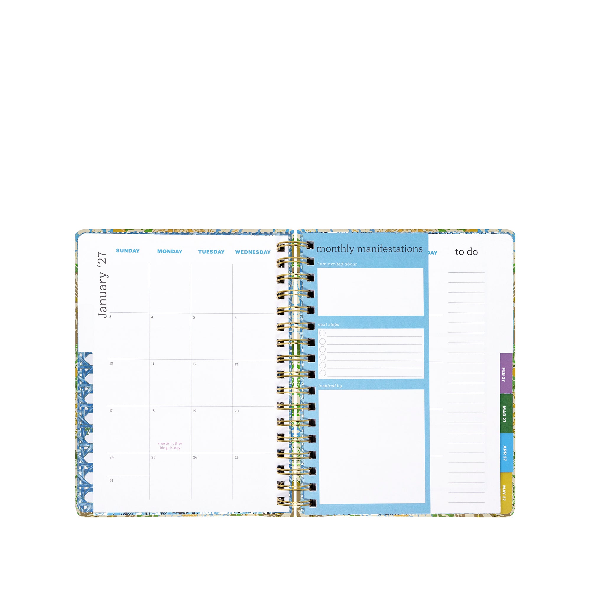 An open spiral-bound planner showing a monthly calendar page on the left, a monthly manifestations and to-do section in the center, and a weekly to-do page on the right, with a floral border and colored page tabs on a white background.