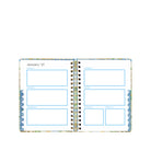 Open planner with monthly layout on a white background