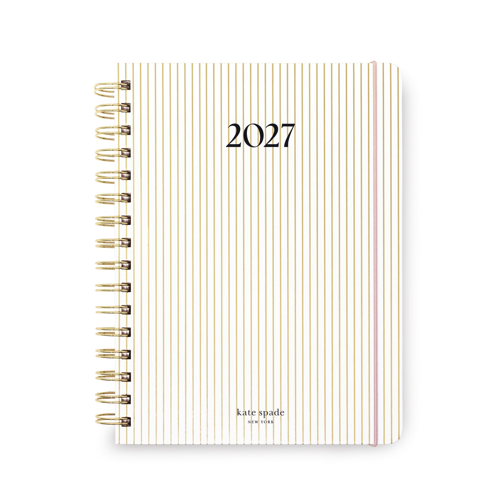 A 2027 spiral-bound planner by Kate Spade New York, featuring a cream cover with thin vertical gold and pink stripes, gold wire binding, and black text.