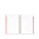 An open spiral-bound planner showing a monthly calendar layout for January 2017, with a light pink cover and white interior pages.