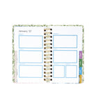 An open spiral-bound planner showing a weekly layout page for January 27 with blue outlined boxes and colorful page tabs on the right, photographed on a plain white background.