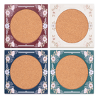 Four round coasters with floral decorative borders on a white background