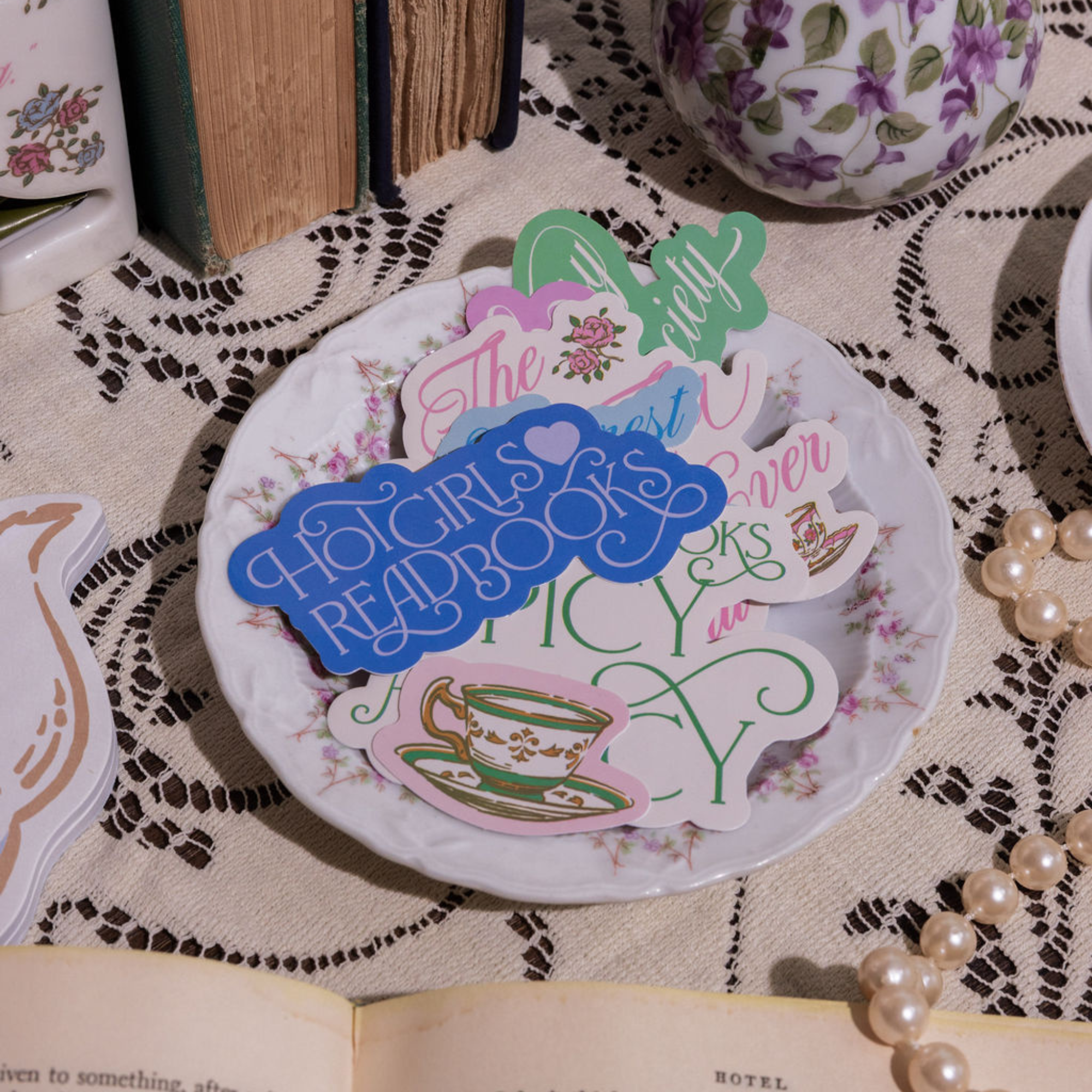 Decorative plate with colorful text and graphics on a lace tablecloth.
