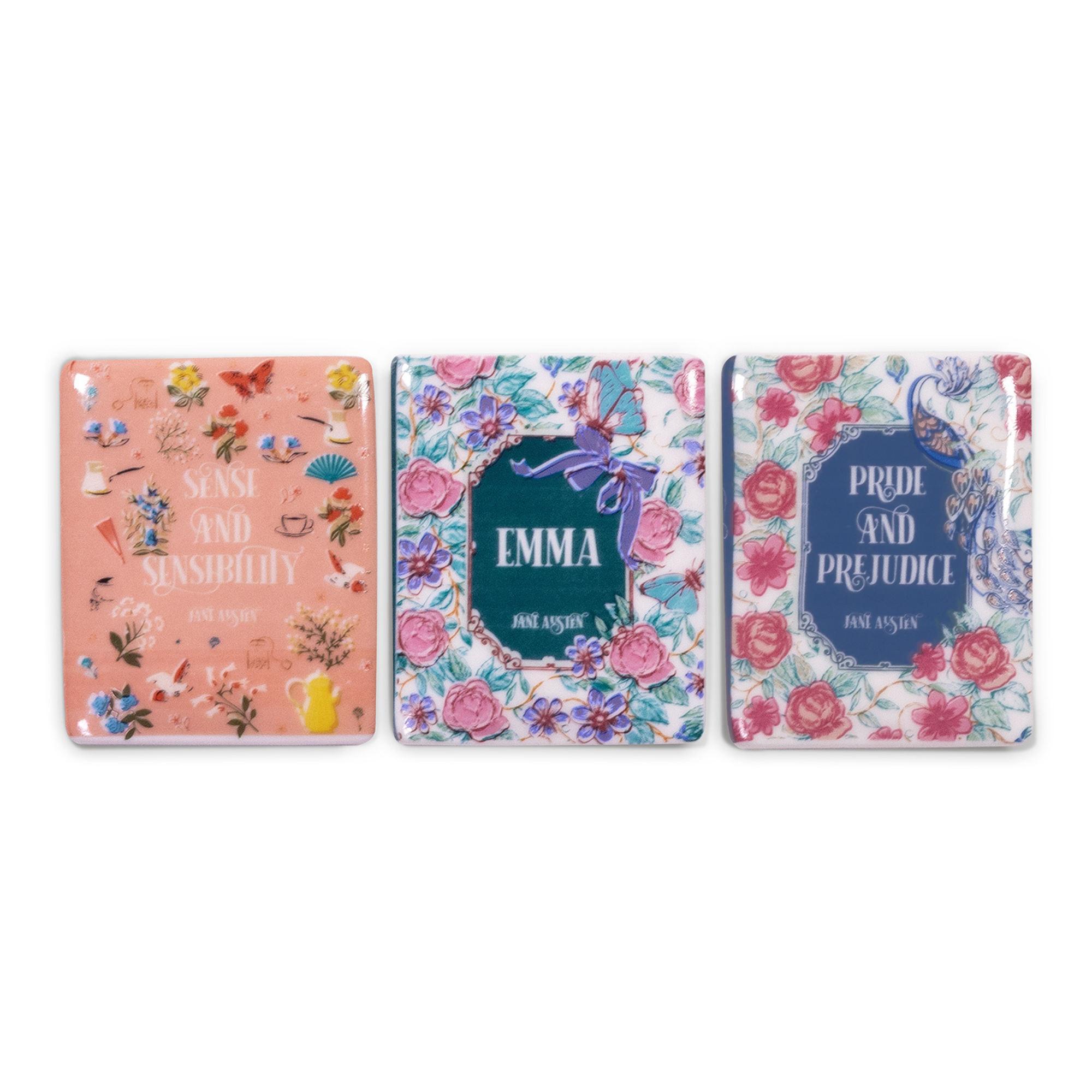 Three book-themed magnets with floral designs and book titles on a white background