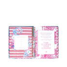 planner with floral design and motivational quote on a white background