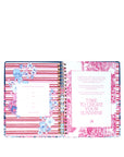 planner with floral design and motivational quote on a white background