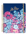 Floral notebook with gold spiral binding on a white background