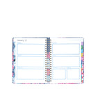 Open planner with colorful floral design on a white background