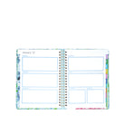 Open planner with colorful design on a white background